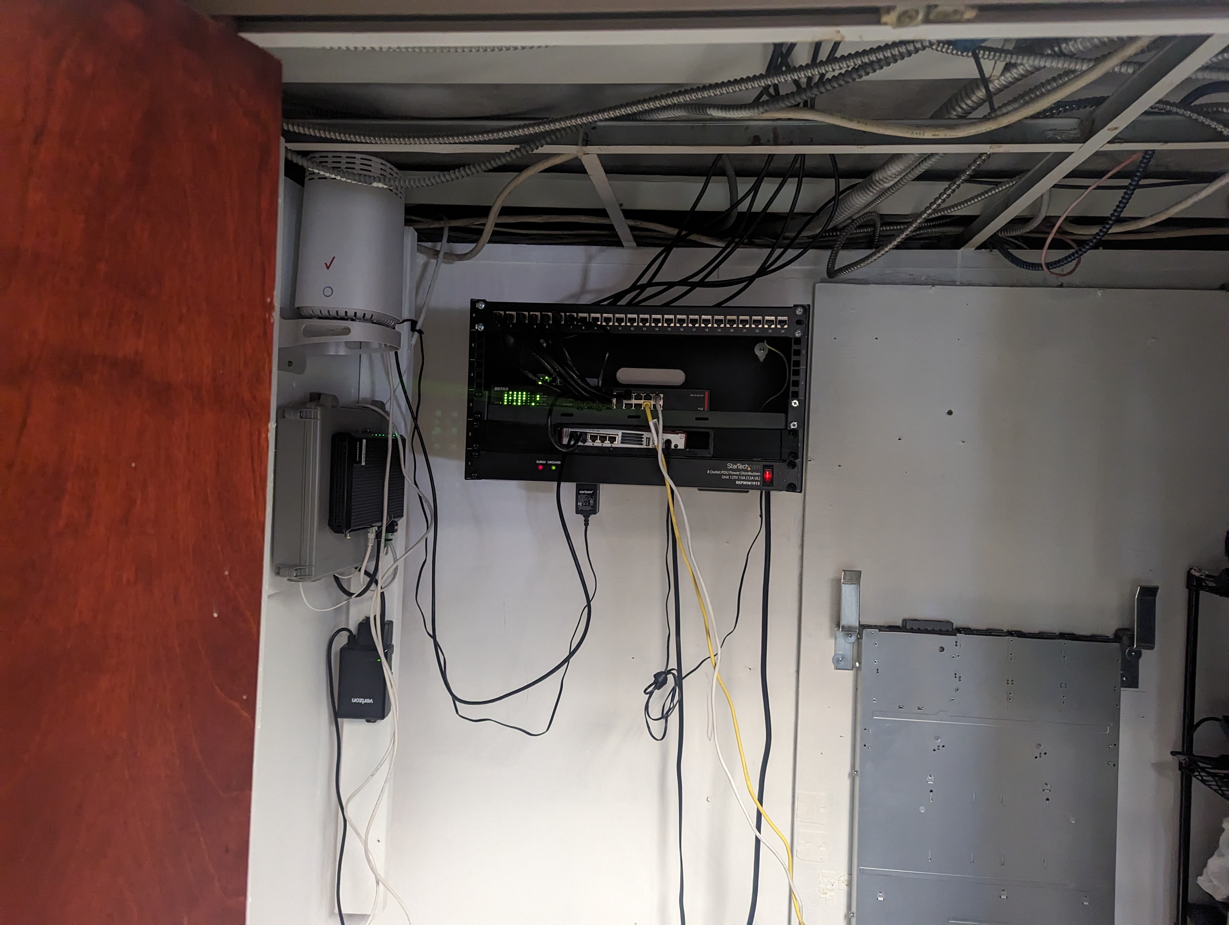 Wall-mounted network patch panel, power distribution unit, and internet equipment installed for a nonprofit client